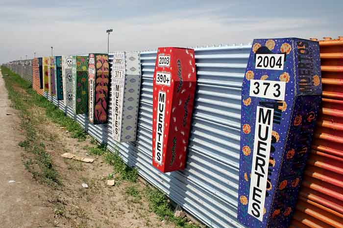 Display of colorful coffins in Tijuana representing border deaths